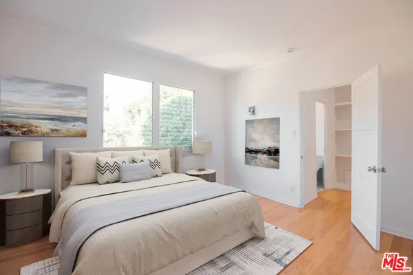 a bedroom with a large bed and a window