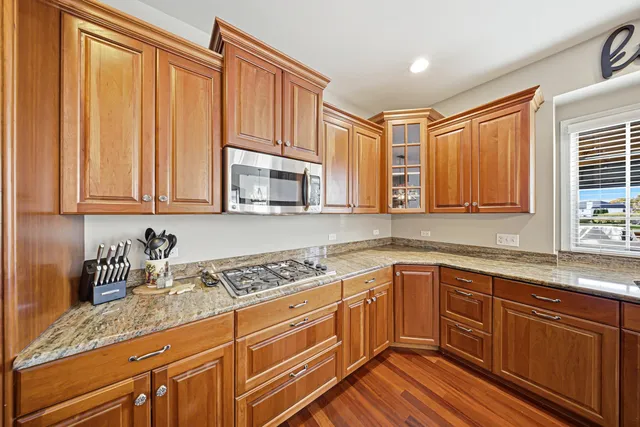 a kitchen with stainless steel appliances granite countertop a sink stove and cabinets