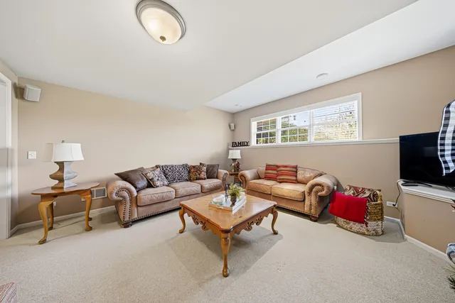 a view of a livingroom with furniture and a window