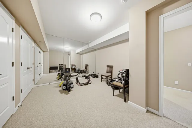 a bedroom with a large bed and ceiling fan