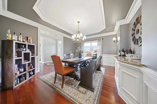 a view of a dining room with furniture and chandelier