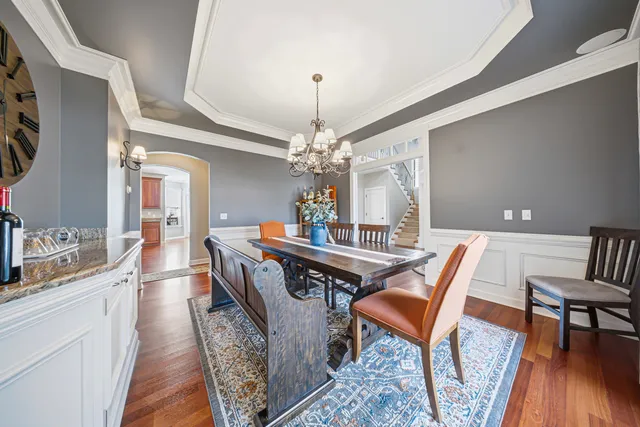 a dining room with furniture and wooden floor