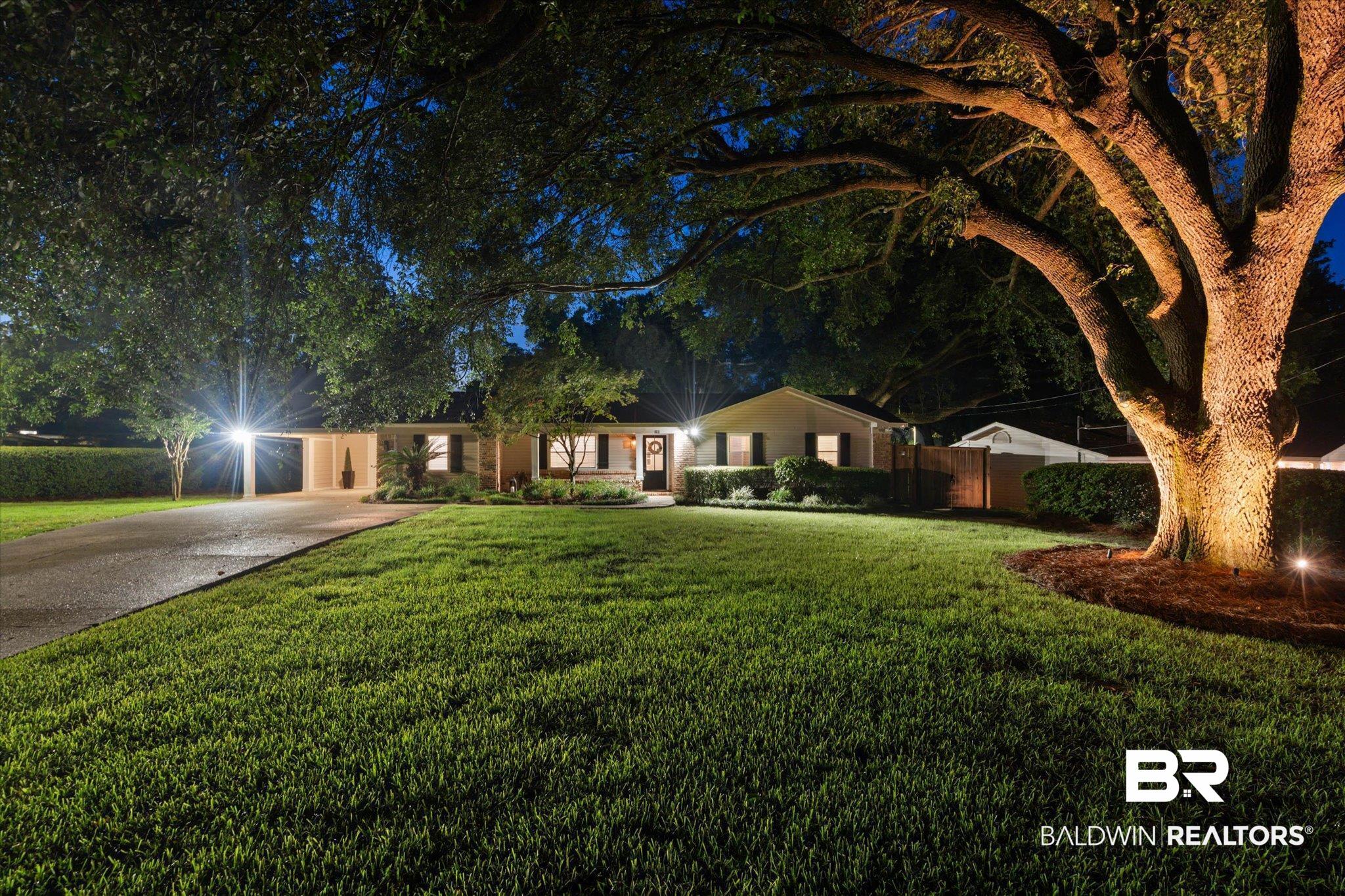 101 Ann Street Daphne, AL 36527 - Photo 35 of 38 Manicured front lawn with mature trees and accent lighting