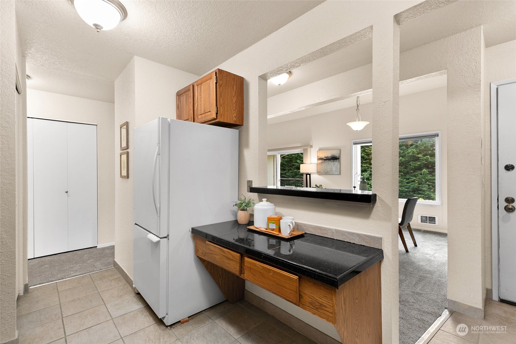 13626 Northeast 7th Street, Unit F16 Bellevue, WA 98005 - Photo 11 of 22 a kitchen with stainless steel appliances granite countertop a refrigerator sink and white cabinets