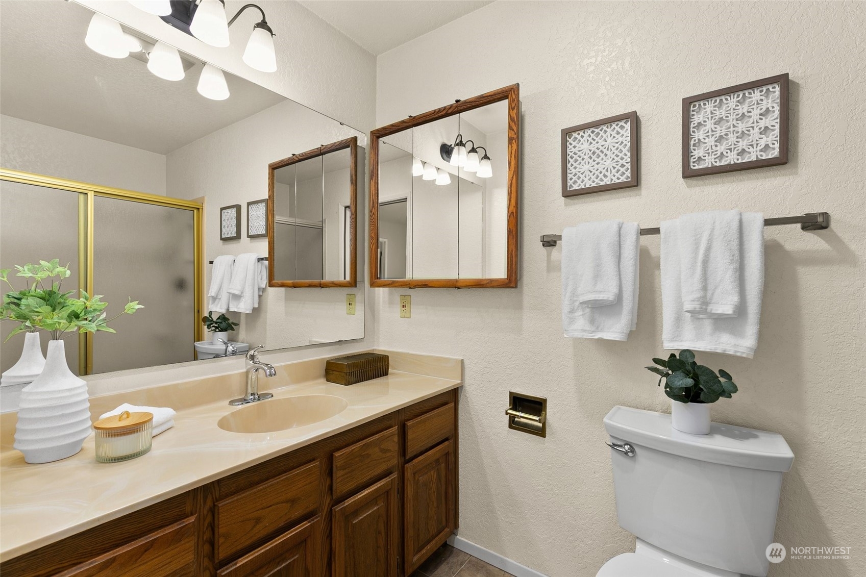 13626 Northeast 7th Street, Unit F16 Bellevue, WA 98005 - Photo 16 of 22 a bathroom with a sink a mirror and a toilet
