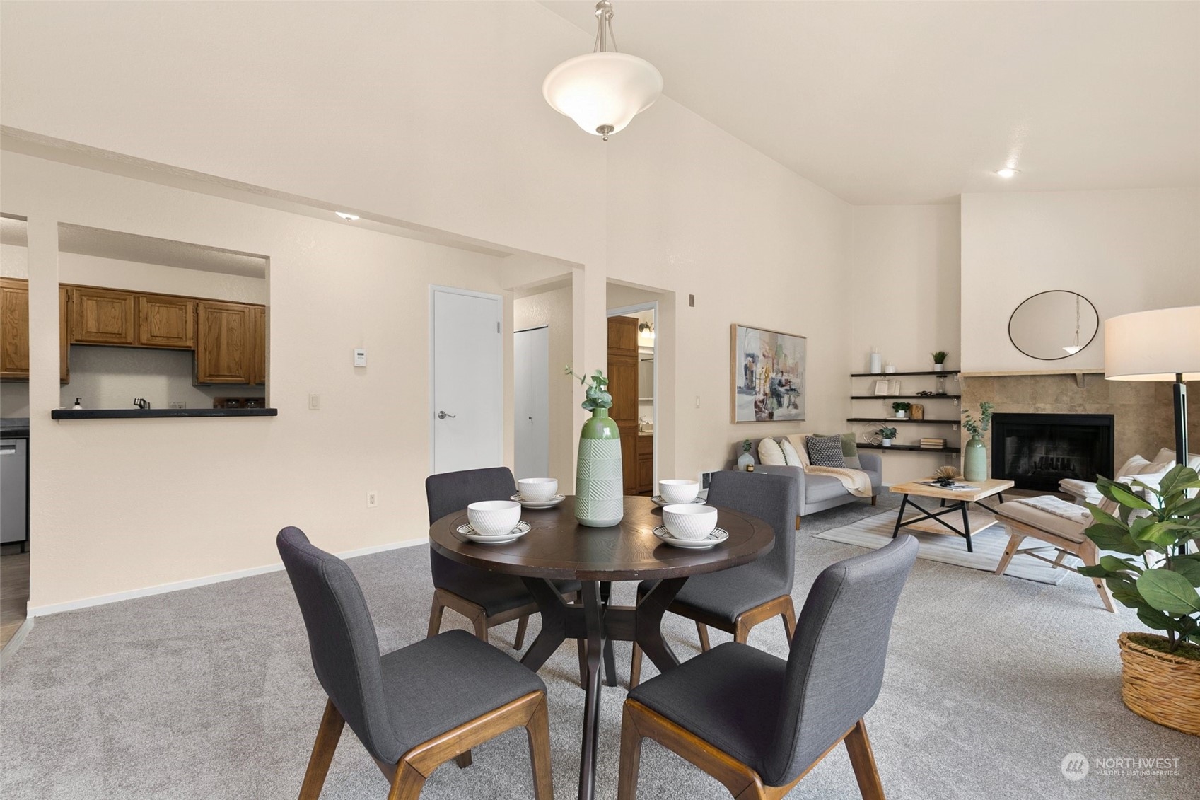 13626 Northeast 7th Street, Unit F16 Bellevue, WA 98005 - Photo 7 of 22 a view of a dining room with furniture wooden floor and a chandelier