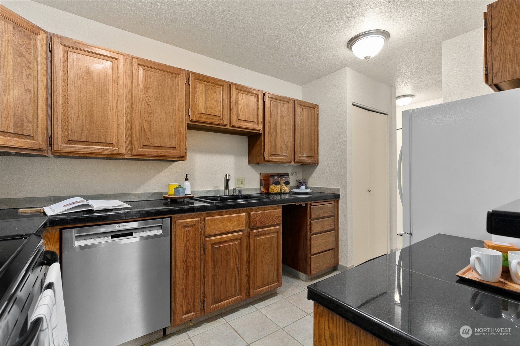 13626 Northeast 7th Street, Unit F16 Bellevue, WA 98005 - Photo 10 of 22 a kitchen with stainless steel appliances granite countertop a sink stove and refrigerator