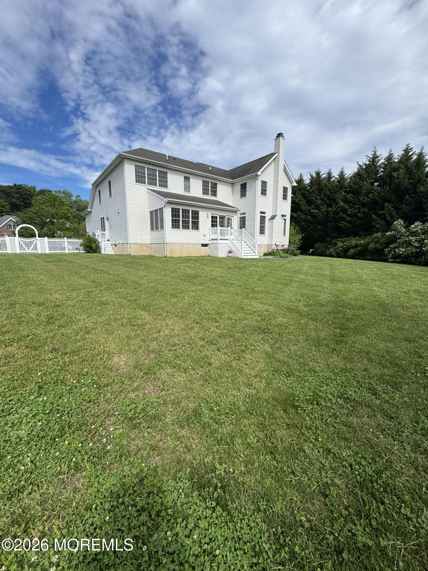 10 Rockingham Court Manalapan, NJ 07726 - Photo 62 of 91 a view of white house with a big yard and large trees