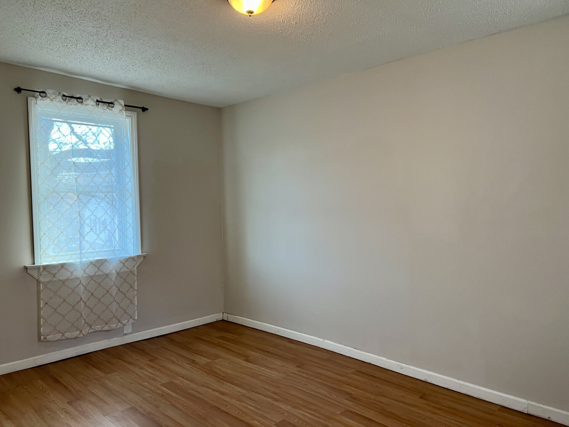 435 Windham Road Windham, CT 06226 - Photo 13 of 20 a view of an empty room with wooden floor and a window