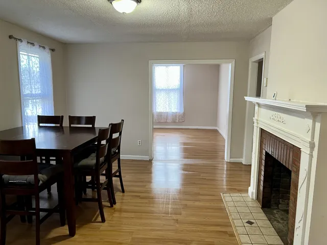 a view of a dining room with furniture and chandelier