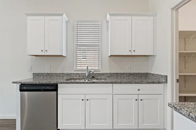 a kitchen with granite countertop white cabinets and a granite counter tops