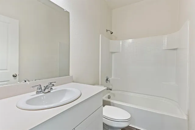 a bathroom with a sink a toilet and a bathtub