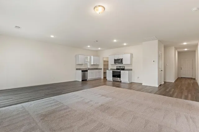 a view of kitchen with kitchen island sink and refrigerator