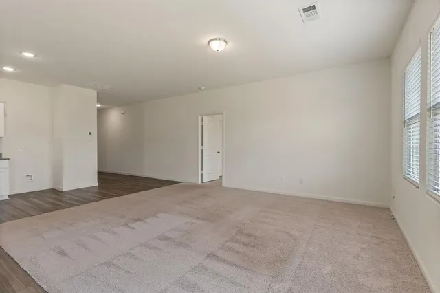 an empty room with windows and closet