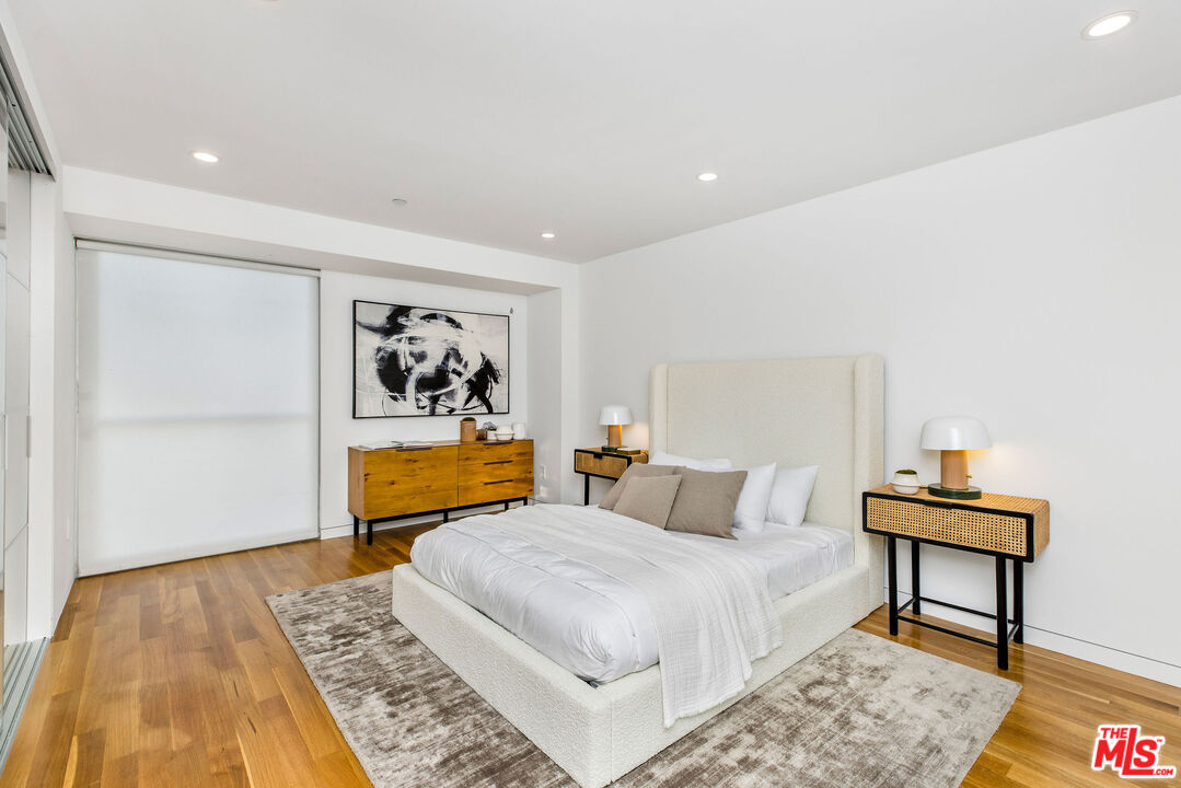 732 Brooks Avenue Venice, CA 90291 - Photo 20 of 28 a bedroom with a bed and wooden floor