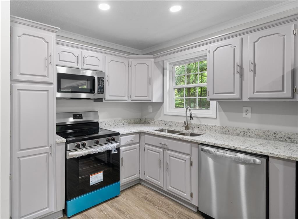 4510 Virginia Avenue Kennesaw, GA 30144 - Photo 11 of 54 a kitchen with granite countertop a sink cabinets and stainless steel appliances
