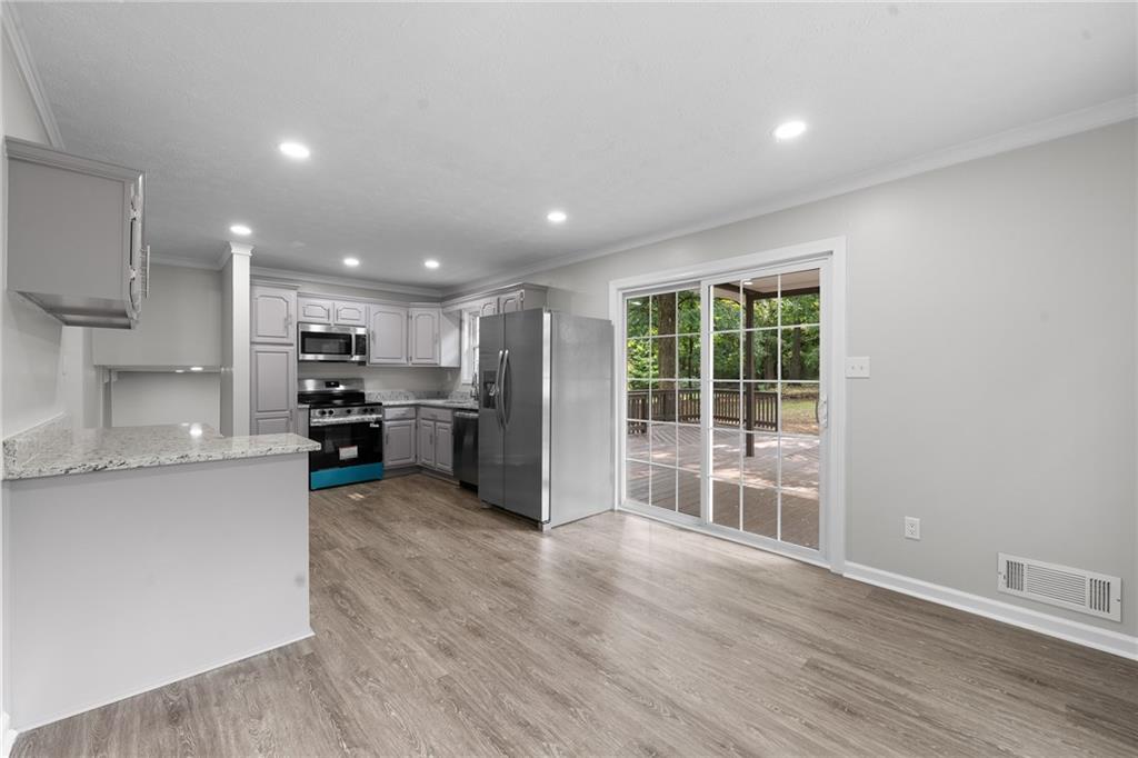 4510 Virginia Avenue Kennesaw, GA 30144 - Photo 16 of 54 a view of a kitchen with kitchen island a counter top space a sink stainless steel appliances and cabinets