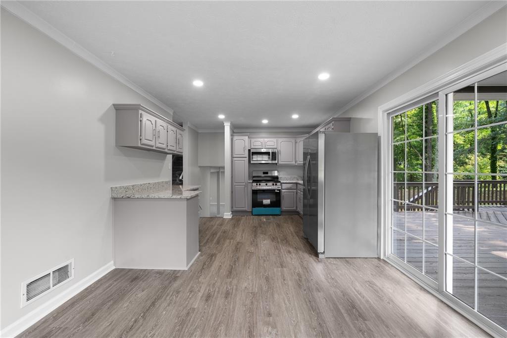 4510 Virginia Avenue Kennesaw, GA 30144 - Photo 17 of 54 a view of a kitchen with furniture and wooden floor
