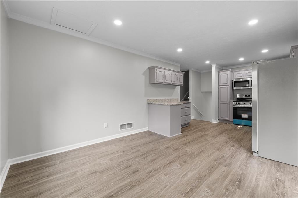 4510 Virginia Avenue Kennesaw, GA 30144 - Photo 18 of 54 a view of kitchen with refrigerator and wooden floor