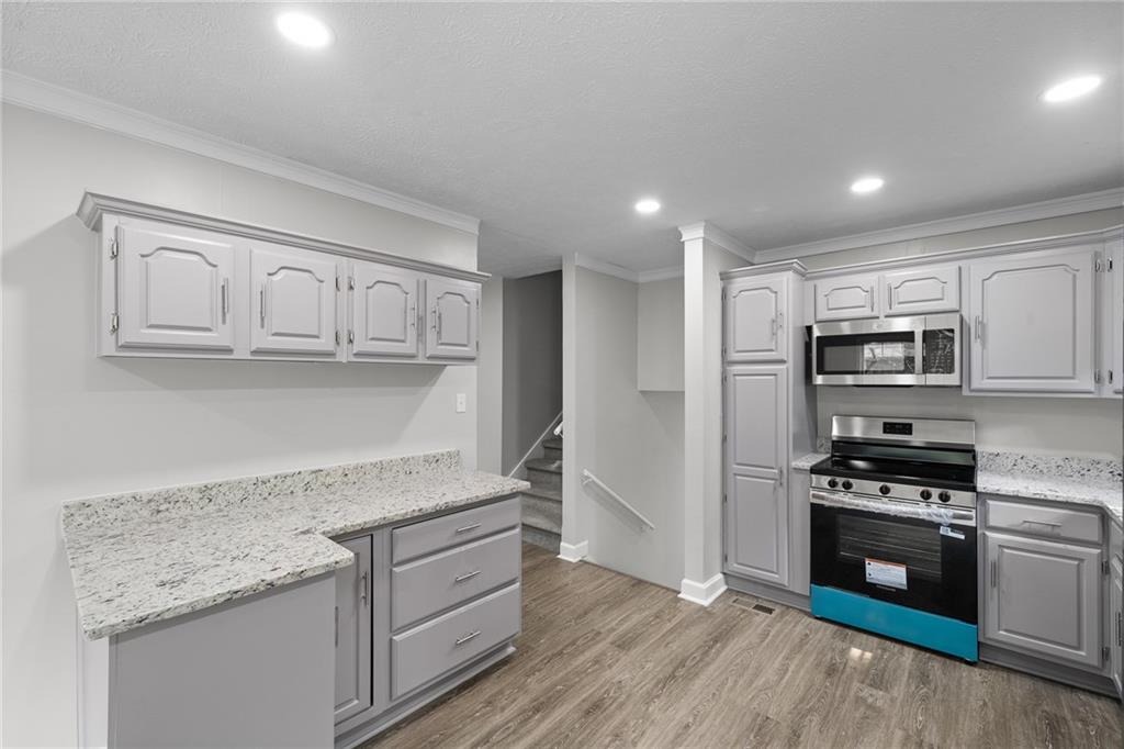 4510 Virginia Avenue Kennesaw, GA 30144 - Photo 19 of 54 a kitchen with stainless steel appliances granite countertop a stove and a refrigerator