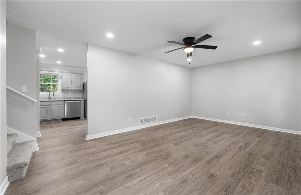 4510 Virginia Avenue Kennesaw, GA 30144 - Photo 20 of 54 an empty room with wooden floor fan and windows