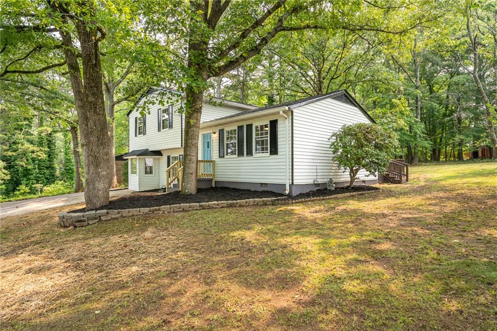 4510 Virginia Avenue Kennesaw, GA 30144 - Photo 3 of 54 a view of a house with a yard and large tree