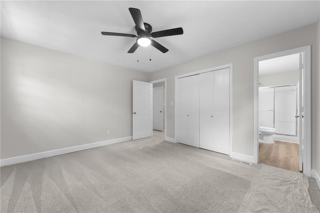 4510 Virginia Avenue Kennesaw, GA 30144 - Photo 33 of 54 a view of a livingroom with a ceiling fan & windows