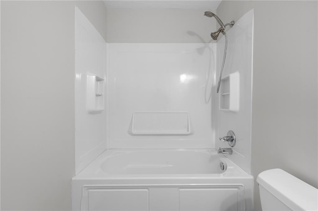 4510 Virginia Avenue Kennesaw, GA 30144 - Photo 35 of 54 a bathroom with a bathtub and a shower