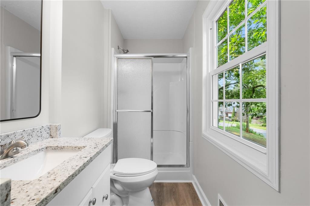 4510 Virginia Avenue Kennesaw, GA 30144 - Photo 38 of 54 a bathroom with a granite countertop sink toilet and shower