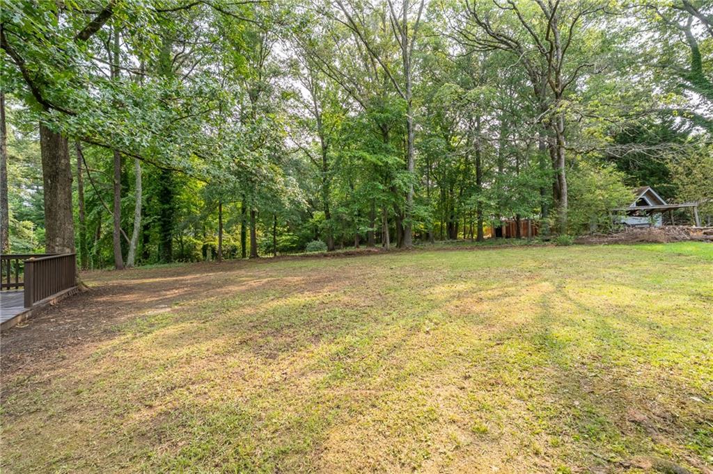 4510 Virginia Avenue Kennesaw, GA 30144 - Photo 48 of 54 a view of a swimming pool with a yard and large trees