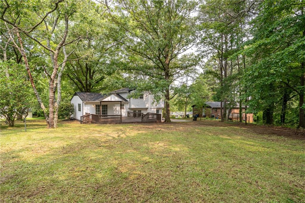 4510 Virginia Avenue Kennesaw, GA 30144 - Photo 51 of 54 a front view of a house with a garden and trees