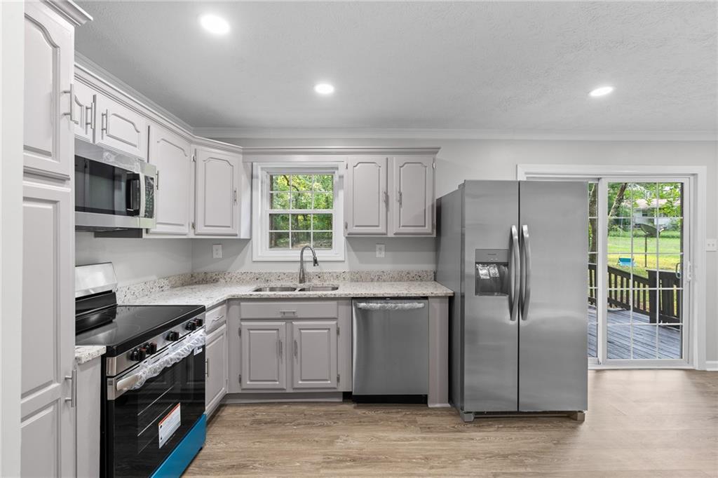 4510 Virginia Avenue Kennesaw, GA 30144 - Photo 10 of 54 a kitchen with stainless steel appliances granite countertop a stove a sink dishwasher a refrigerator and a microwave