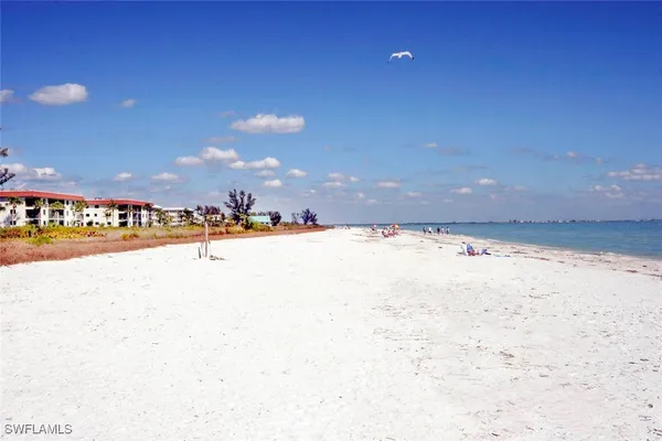 a kitchen with stainless steel appliances granite countertop a kitchen island a stove a table and chairs