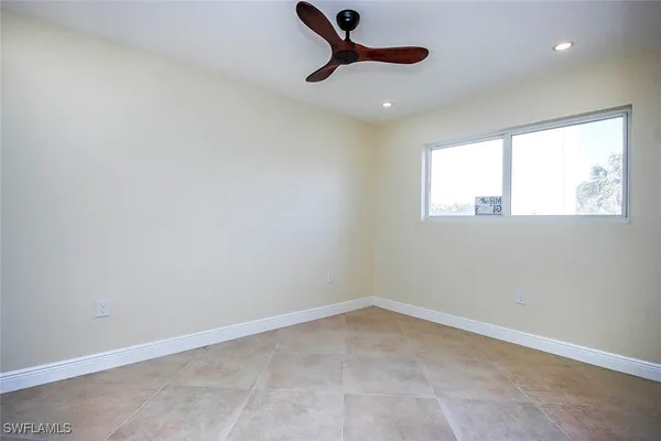 an empty room with closet and windows