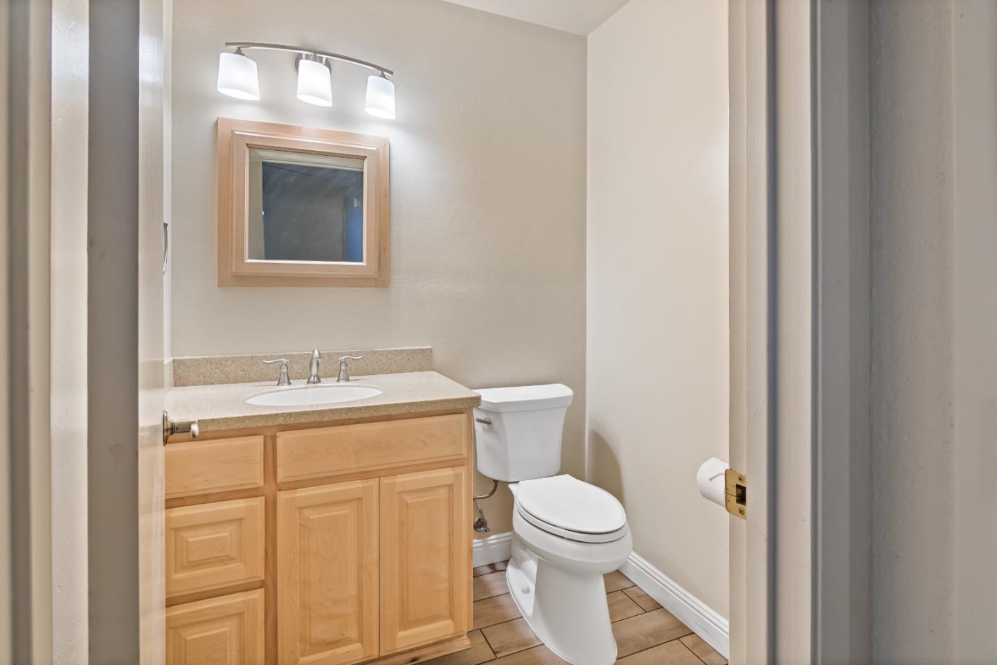 88 River Drive King City, CA 93930 - Photo 10 of 15 a bathroom with a granite countertop toilet a sink and a mirror