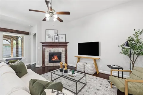 a living room with furniture a fireplace and a flat screen tv