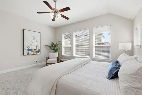 a bedroom with a large bed and a window