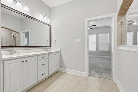 a spacious bathroom with a granite countertop sink mirror and
