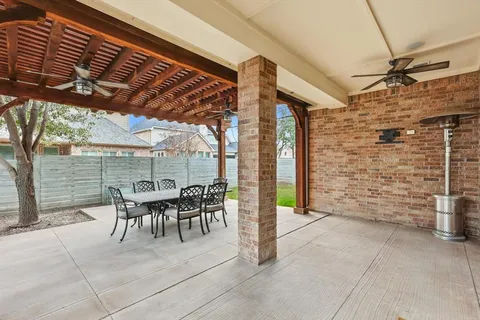 a patio with table and chairs