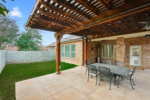 a patio with garden area and furniture