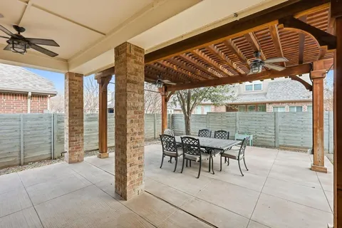 a patio with table and chairs