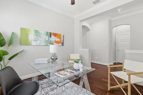 a dining room with furniture and wooden floor