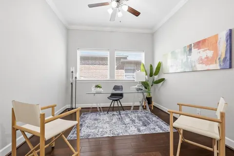 a living room with furniture a table and a potted plant