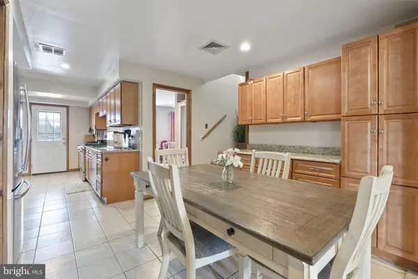 a kitchen with kitchen island granite countertop a stove a sink and a refrigerator