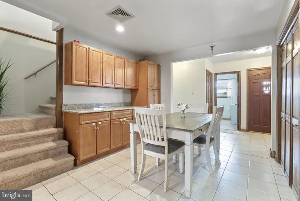 a kitchen with cabinets and chairs