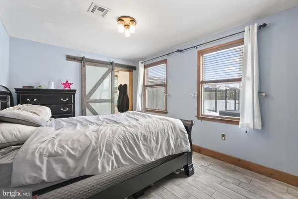 a bedroom with two beds and a window