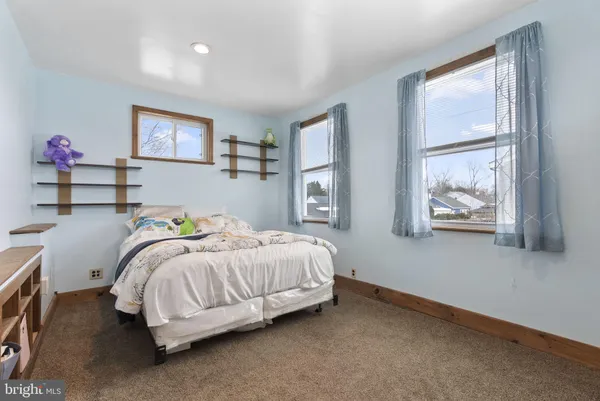 a bedroom with bed and a window