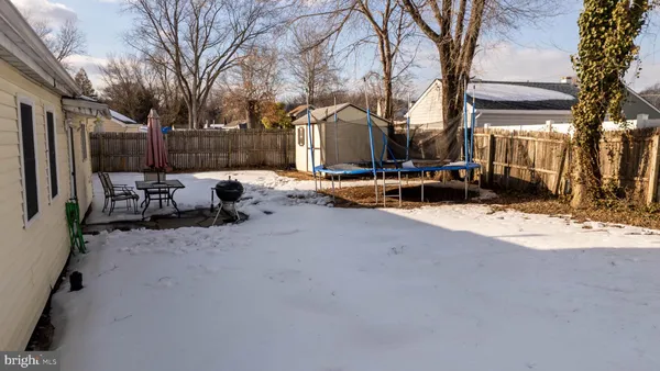 a view of a patio with snow on the road