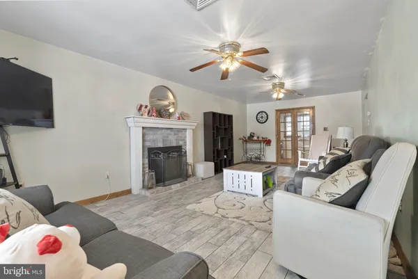 a living room with furniture a flat screen tv and a fireplace
