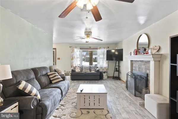 a living room with furniture and a fireplace